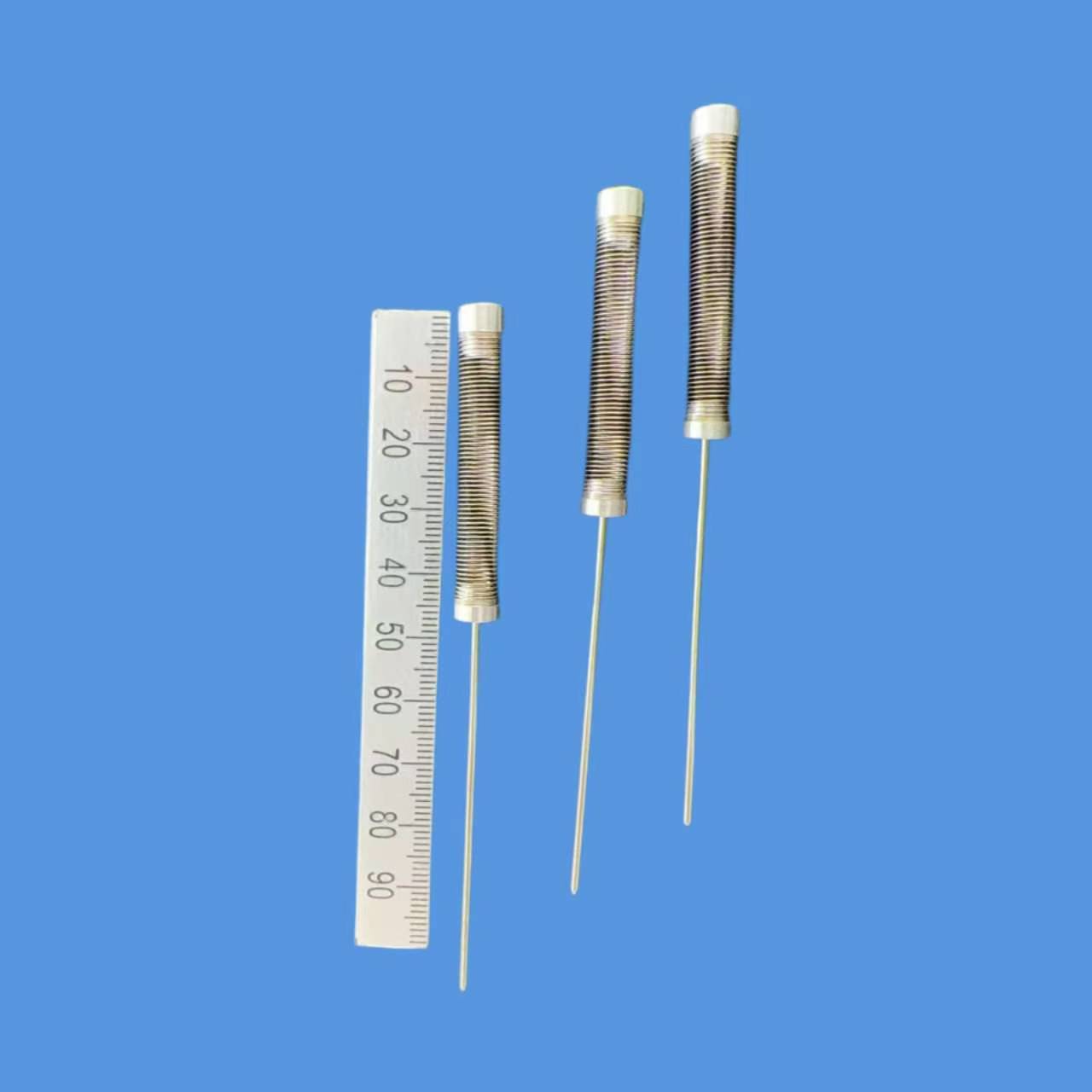 Precision hairspring with ruler for size reference, showing length and dimensions